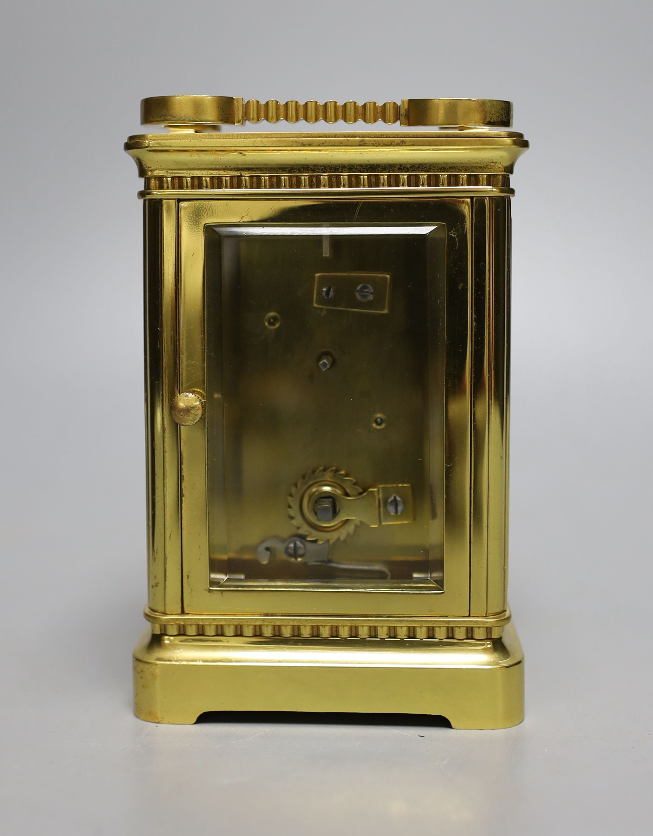 A cased French gilt brass carriage timepiece with relief cast dial and engraved presentation inscription - 14cm tall